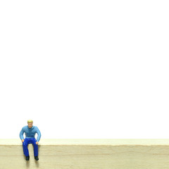 Selective focus, miniature people sitting on wooden block, busin