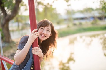 Portrait of cute young woman smiling relaxing in park enjoying her freedom wear short dress