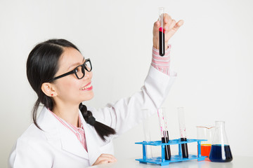 Fototapeta premium Asian female scientist doing experiment in lab
