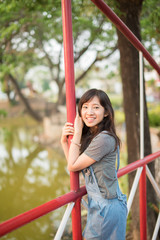 Portrait of cute young woman smiling relaxing in park enjoying her freedom wear short dress