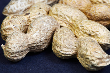 Few peanuts   /   Few paddy peanuts. Focus is on the front.