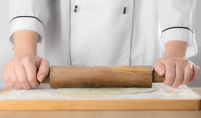 rolls the dough a rolling pin