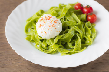 Spinach pasta with poached egg