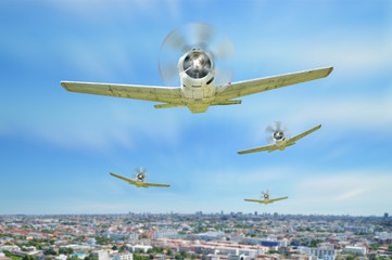 Retro vintage warplanes fly with on city.