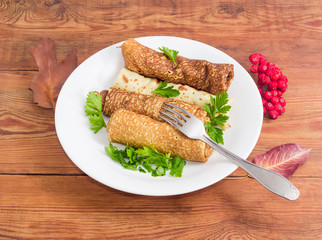 Pancakes filled with meat stuffing on white dish