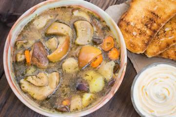 Mushroom soup with cream. Wooden background. Top view