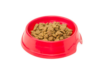 Dry cat food in a red plastic bowl
