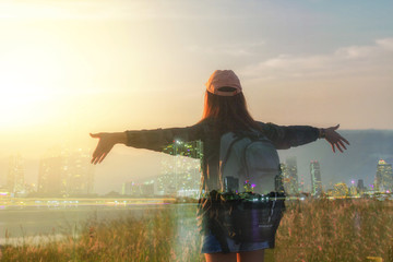 Double exposure Freedom traveler woman standing with raised arms and enjoying a beautiful nature and cheering young woman backpacker at sunrise seaside mountain peak