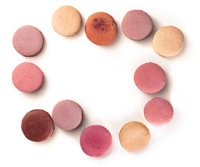 Pastel coloured macarons forming a frame on white
