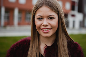 Pretty blonde girl with fur coat