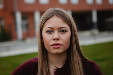 Obraz premium Pretty blonde girl with fur coat
