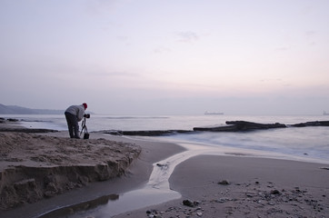Photographer takes pictures panorama of the sea seaside