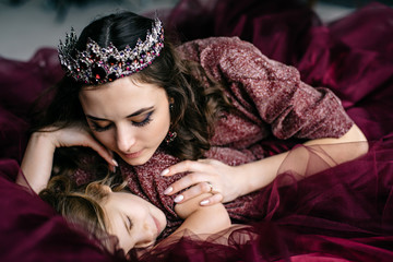 mother and daughter in the image of the queen and princess dress © MZaitsev