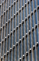 Obraz premium Lighting equipment on facade of modern office building. Lamps illuminate the exterior at night.