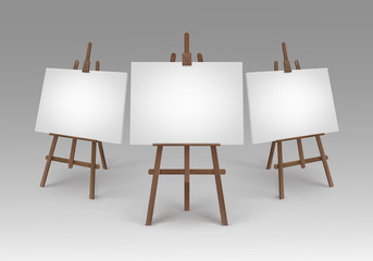 Set of Brown Wooden Easels with Mock Up Empty Blank Canvases Isolated on Background