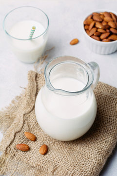 Jug of almond milk on linen cloth. Healthy, vegan dairy-free milk.