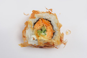 Piece of chicken and salmon teriyaki roll.