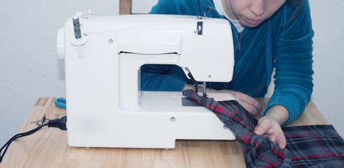 Woman Uses Sewing Machine