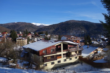 Fototapeta na wymiar Broad view over Busteni mountain resort in Romania in winter