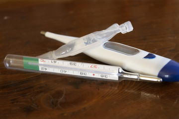 flu treatment with medicine and thermometer