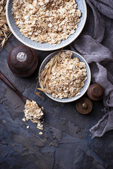 Oat flakes in bowl and spikelets
