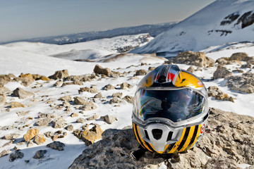 Snowmobile helmet on a background of mountain scenery. State Nature Reserve in Adygea, Russia