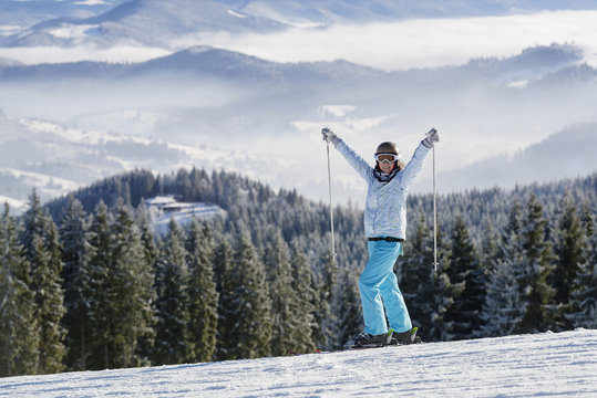 Happy female skier on a slope