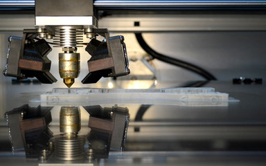 3d printer printing gray objects on mirror reflective surface close-up