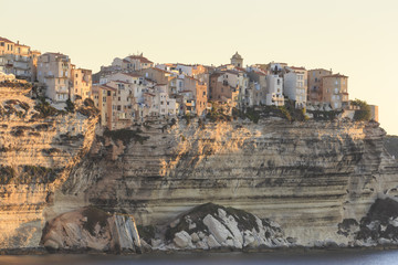 Old citadel townhouses and church at dawn, in early morning light, seen from the sea, Bonifacio, Corsica, France, Mediterranean