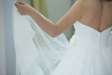 Bride white wedding dress from side view, shallow focus, tulle cloth