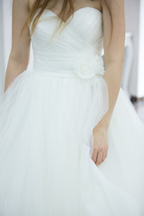 Fototapeta na wymiar Bride white wedding dress, shallow focus, tulle cloth, vertical