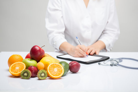Healthy life style concept, doctor writing, diet and losing weight