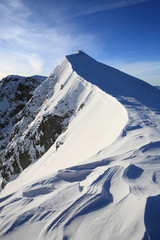 The climber climbs to the top of the mountain in the Carpathians