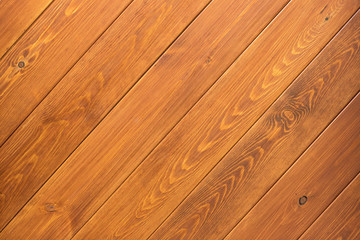 Natural wooden orange background, rough texture of hardwood planks for floors and walls in the construction of the house