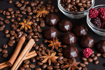 Chocolate sweets, coffee beans, dry raspberries background