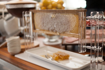 Setting of the table with food for breakfast, beverage in buffet, honey