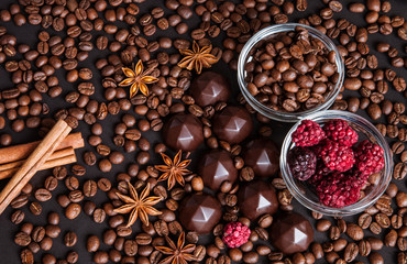 Chocolate sweets, coffee beans, dry raspberries background