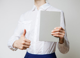 Unrecognizable woman holding a book