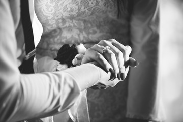 Hands of the woman and man holding each others', couple in love, black and white