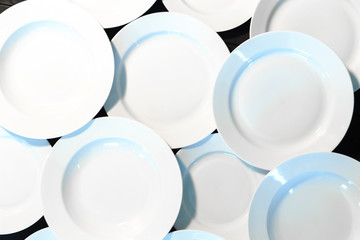 Empty white plates on wooden table