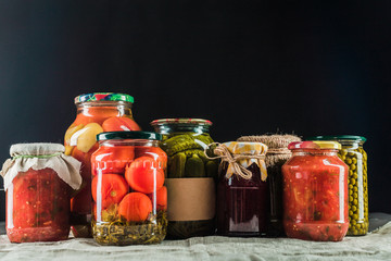 Preserved vegetables on wooden background