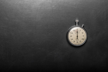 pocket watch on a black table