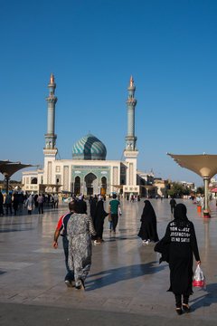 Astane Square in front of the Imam Hassan Mosque, unusually challenging message (Can't Get No Satisfaction) on girl's back, Iran