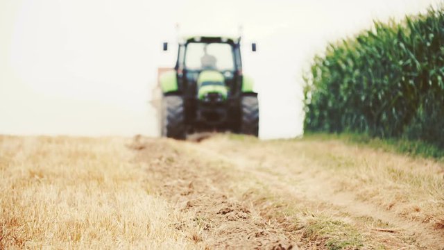 Agricultural tractor sowing and cultivating field