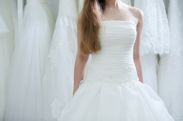 Fototapeta na wymiar Wedding bridal white dress in the showroom fashion, abstract
