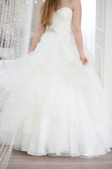 Obraz na płótnie Canvas Wedding bridal white dress in the showroom fashion, abstract, vertical
