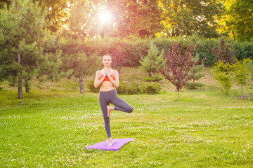 Young woman practicing yoga in the park.