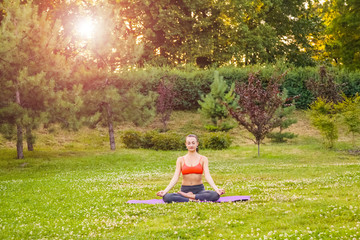 Young woman practicing yoga in the park.