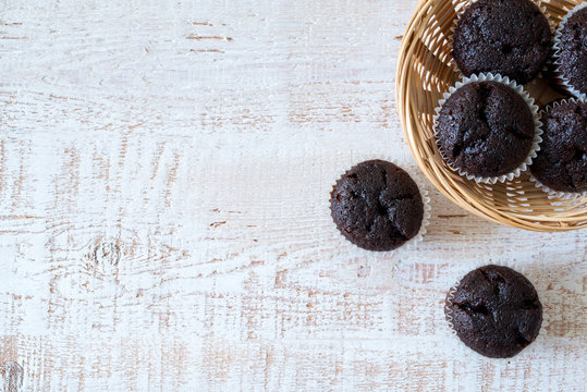 Chocolate muffins on a white rustic wooden table - selective focus, copy space