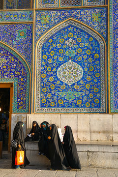 Girls gossiping after shopping in the Grand Bazaar, by entrance of Sheikh Lotfollah Mosque, Isfahan, Iran